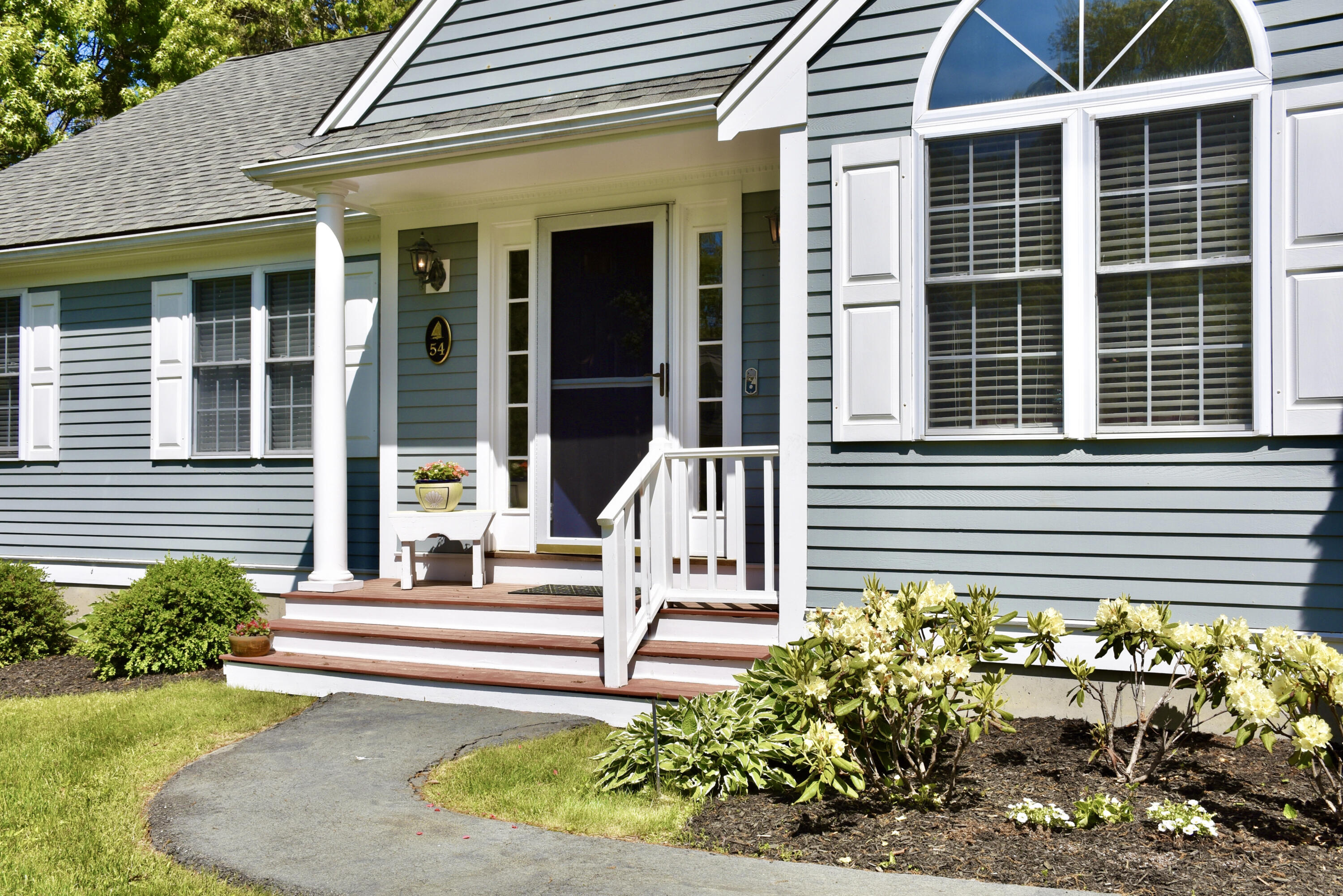 54 Snead Drive Mashpee, MA 02649 - Photo 3 of 32 a front view of a house with a garden