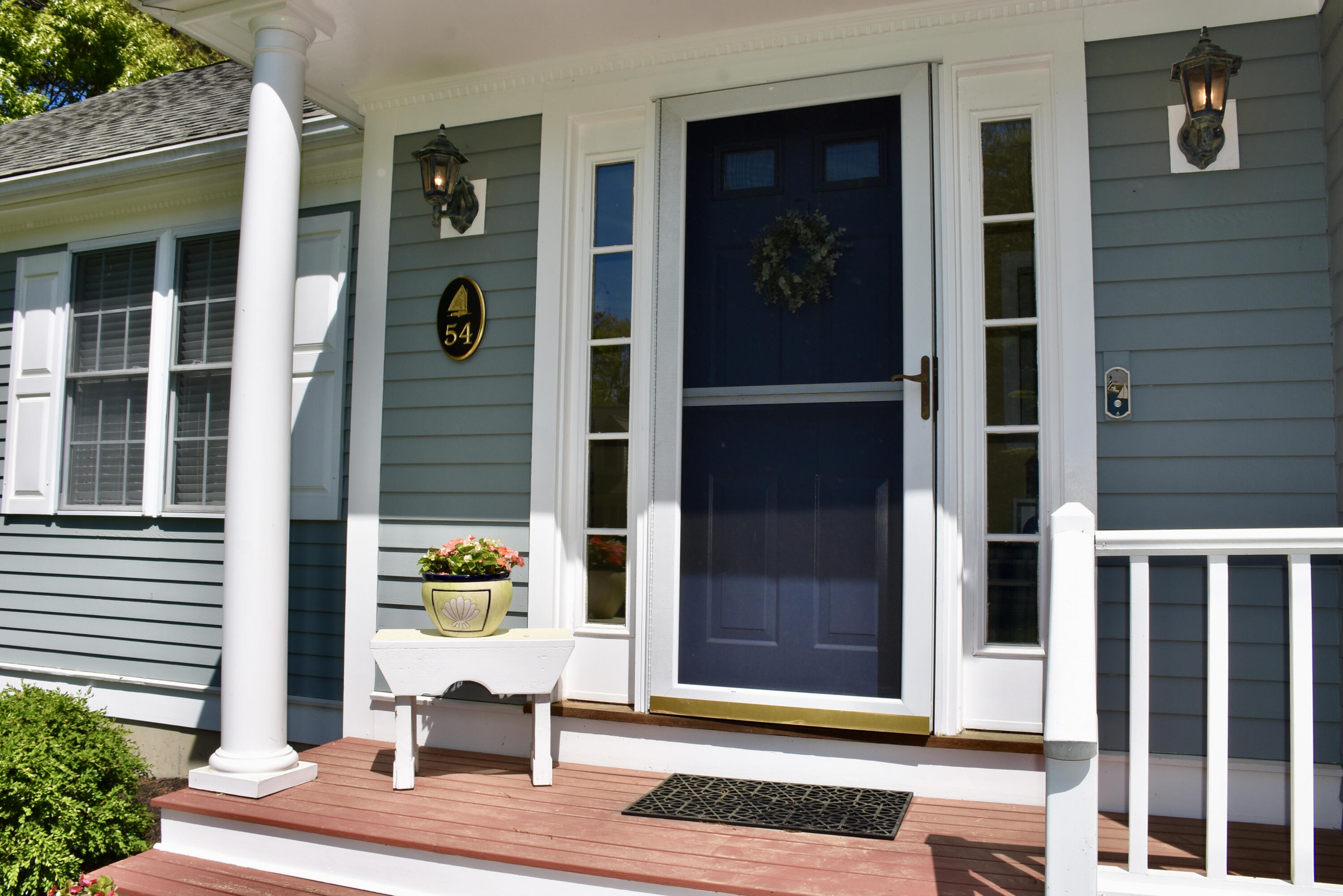 54 Snead Drive Mashpee, MA 02649 - Photo 5 of 32 a view of a brick building with a bench in front
