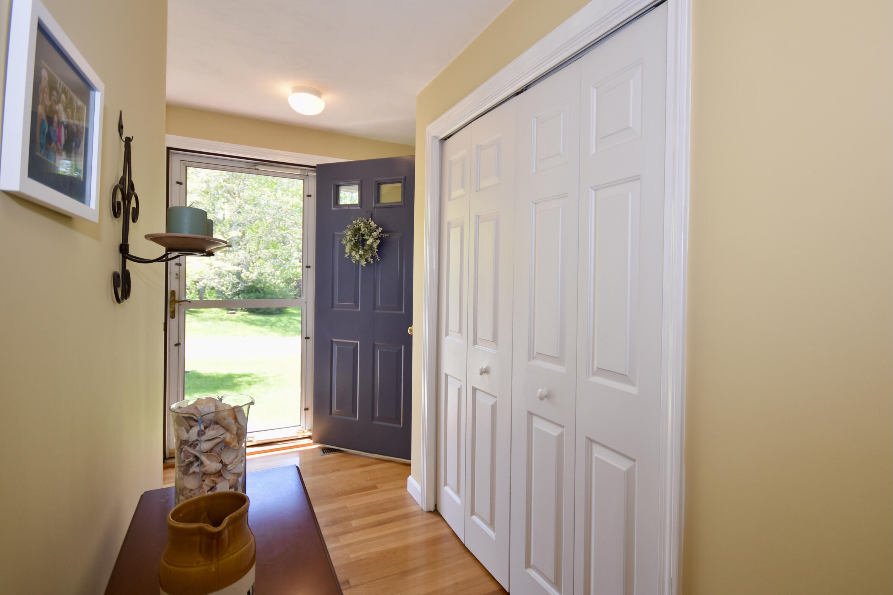 54 Snead Drive Mashpee, MA 02649 - Photo 6 of 32 a hallway with sliding door and wooden floor