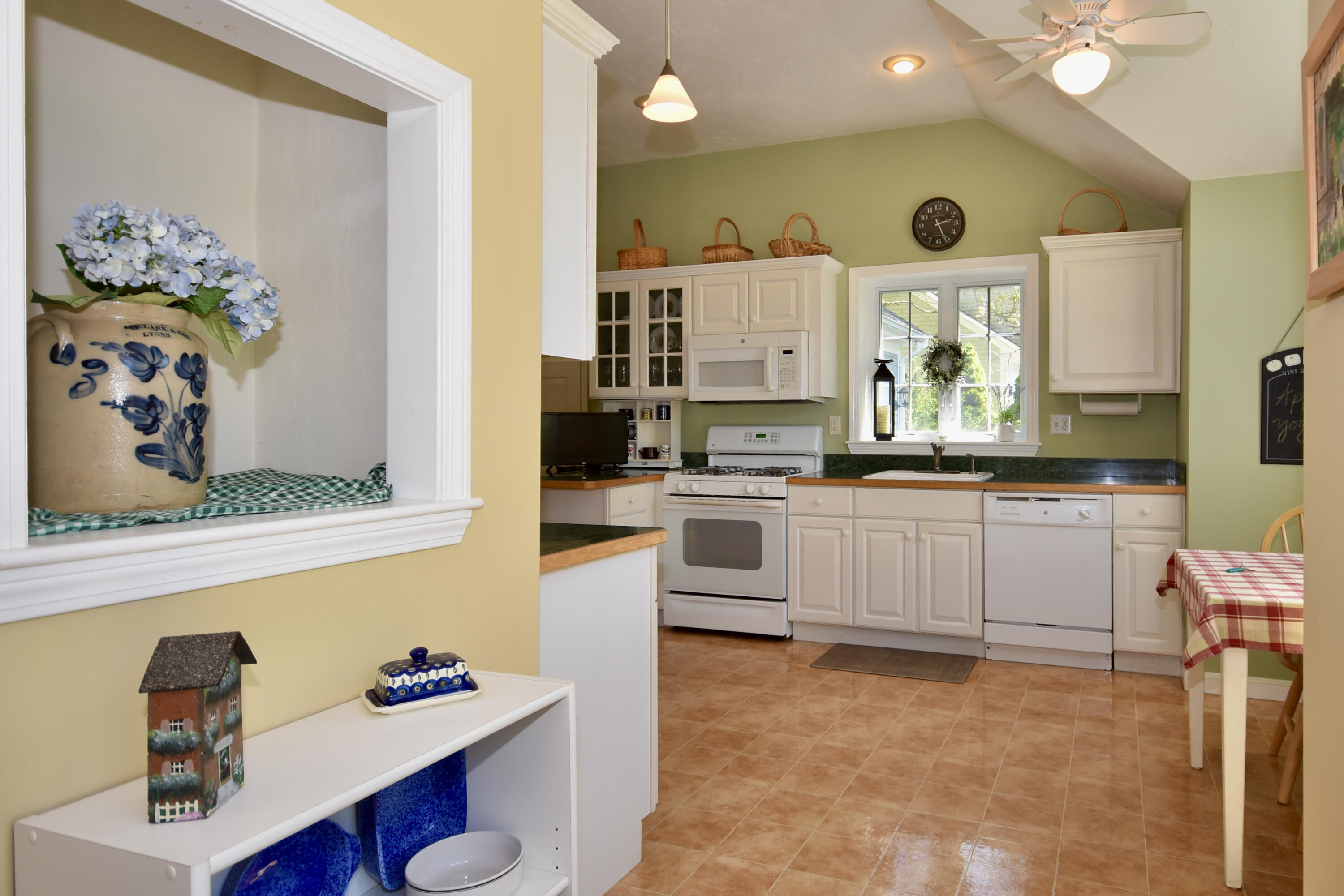 54 Snead Drive Mashpee, MA 02649 - Photo 8 of 32 a kitchen with white cabinets and appliances