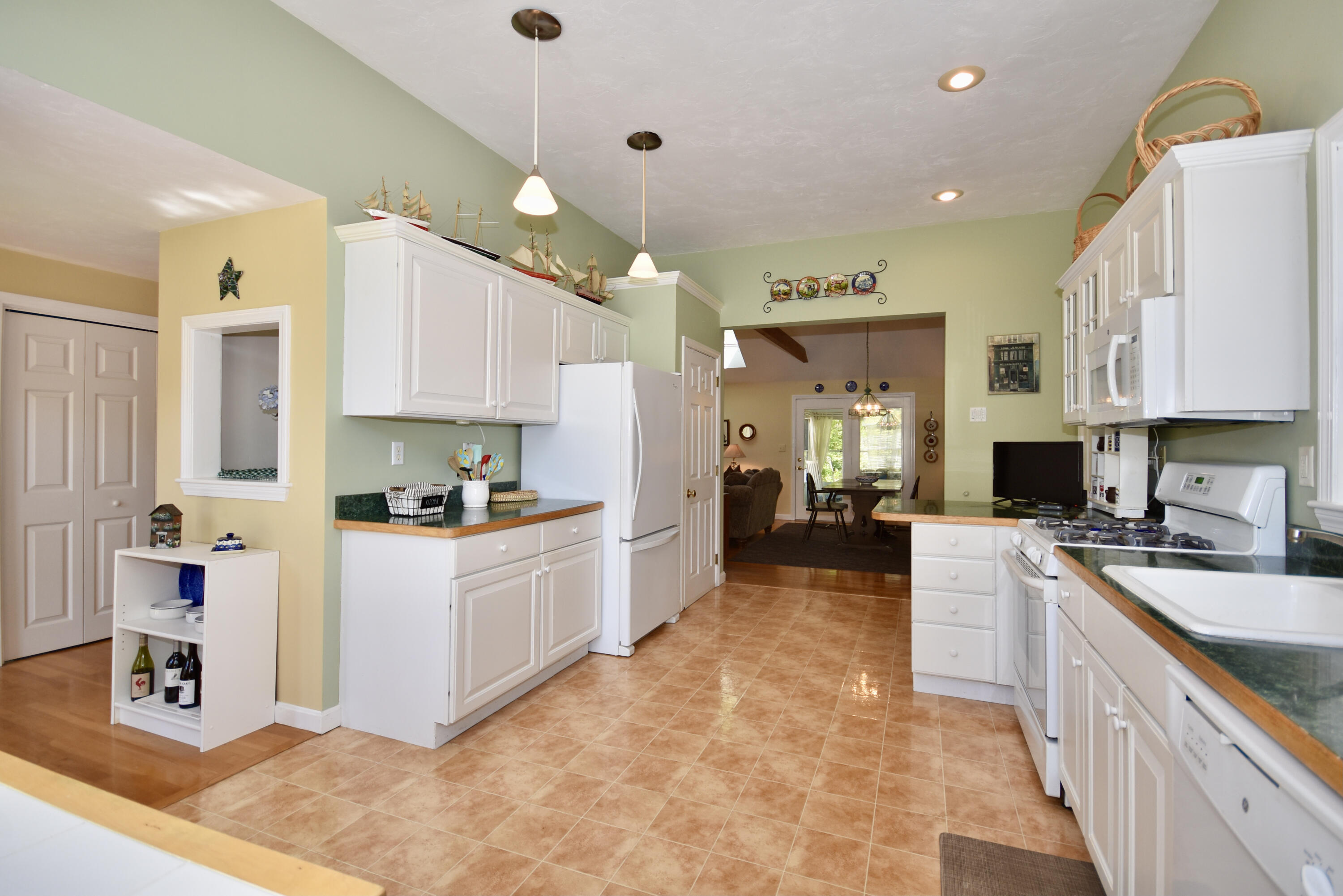 54 Snead Drive Mashpee, MA 02649 - Photo 9 of 32 a large kitchen with stainless steel appliances lots of counter space and a sink