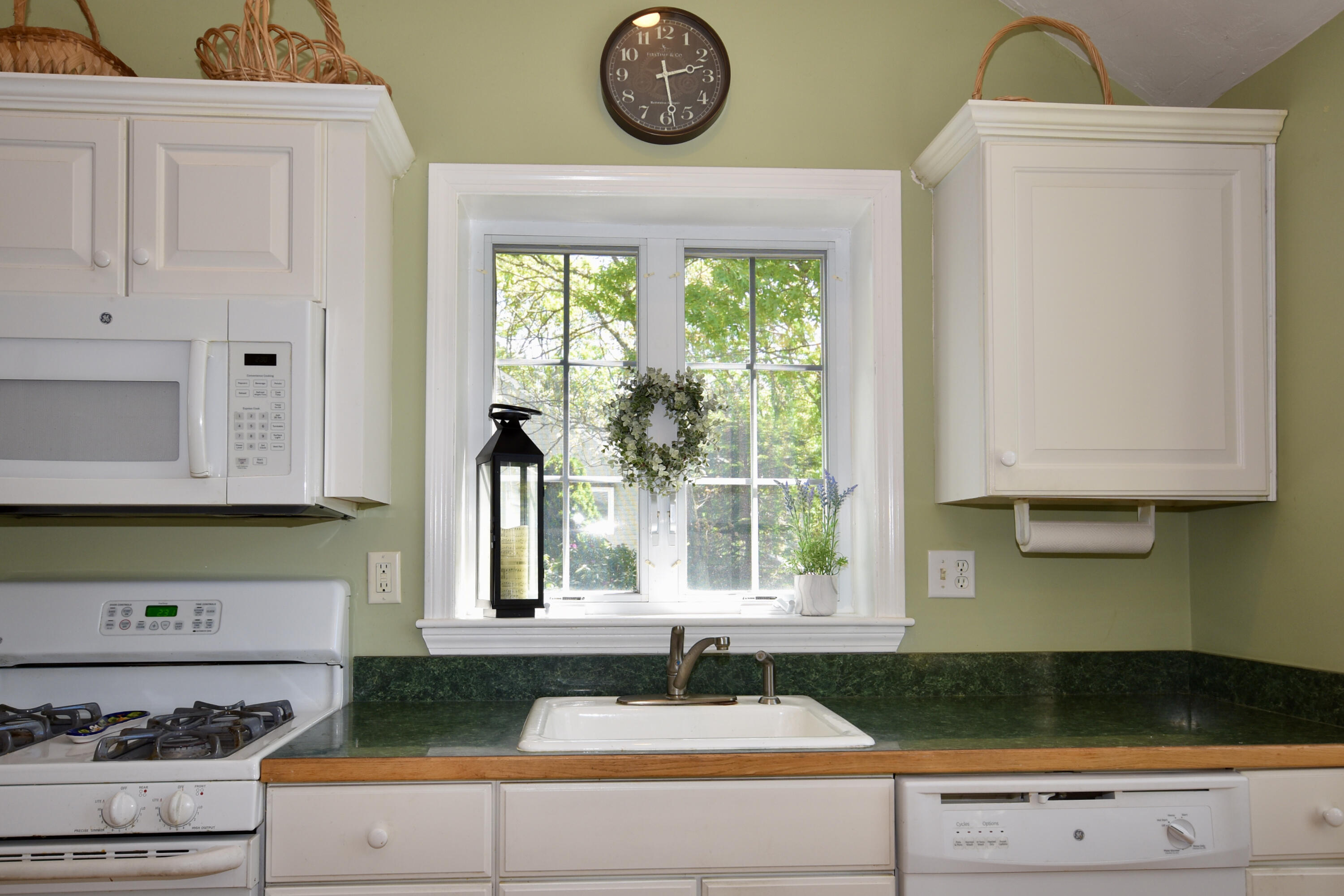 54 Snead Drive Mashpee, MA 02649 - Photo 10 of 32 a kitchen with a stove a refrigerator and a window