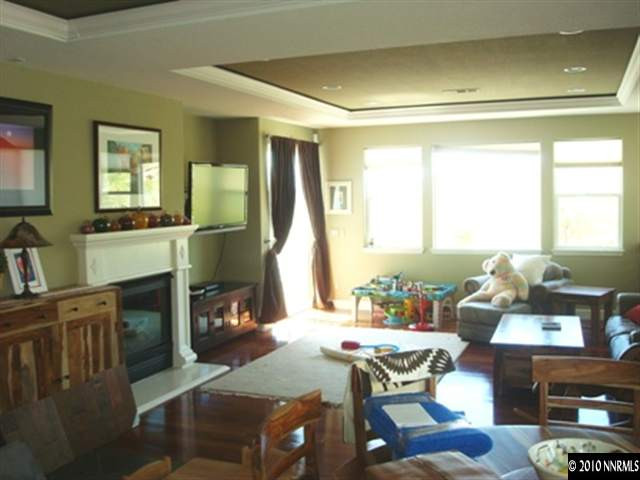 7005 Cour Street Reno, NV 89511 - Photo 7 of 9 a living room with fireplace furniture and a large window