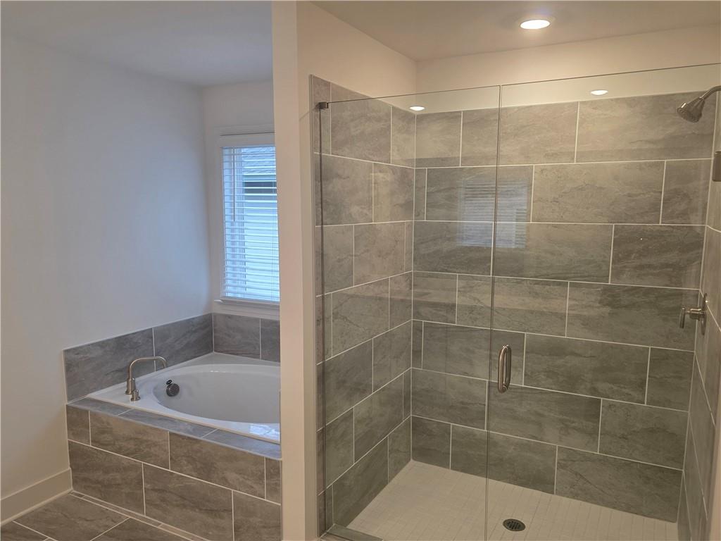 221 Brownlee Road Woodstock, GA 30188 - Photo 21 of 33 a bathroom with a tub shower and a sink