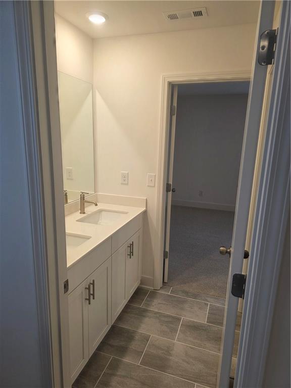 221 Brownlee Road Woodstock, GA 30188 - Photo 24 of 33 a bathroom with a double vanity sink and a mirror