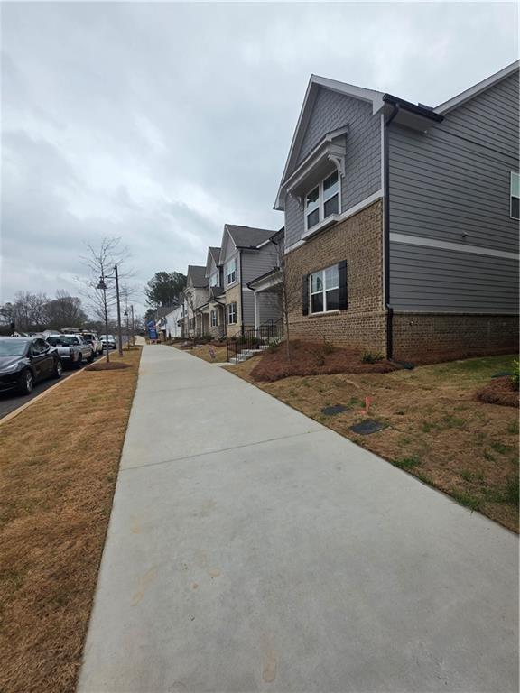 221 Brownlee Road Woodstock, GA 30188 - Photo 4 of 33 a front view of a house with a yard