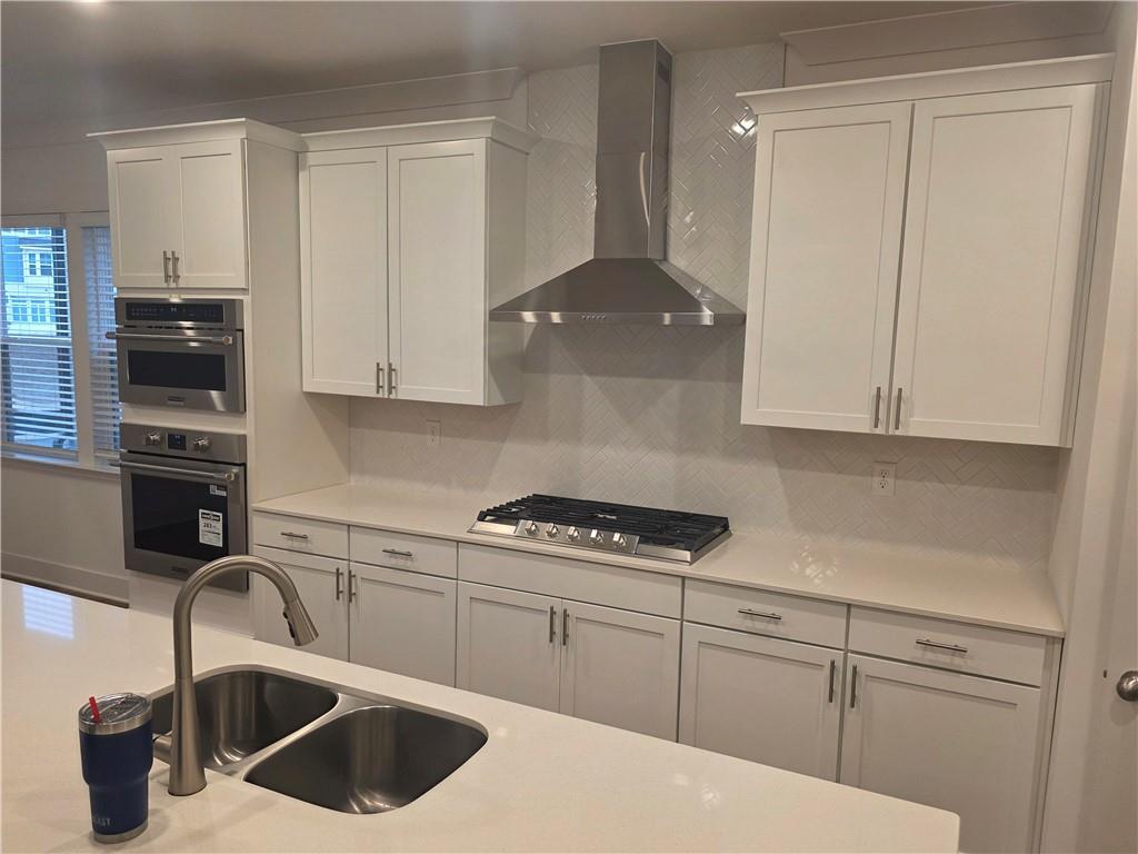 221 Brownlee Road Woodstock, GA 30188 - Photo 6 of 33 a kitchen with stainless steel appliances granite countertop a sink a stove and cabinets