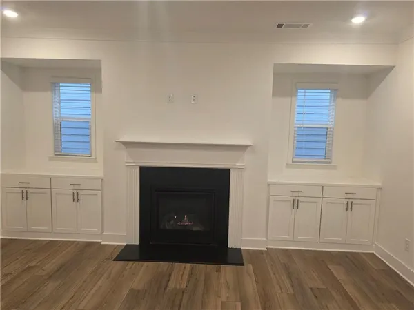 a view of a livingroom with a fireplace and wooden floor