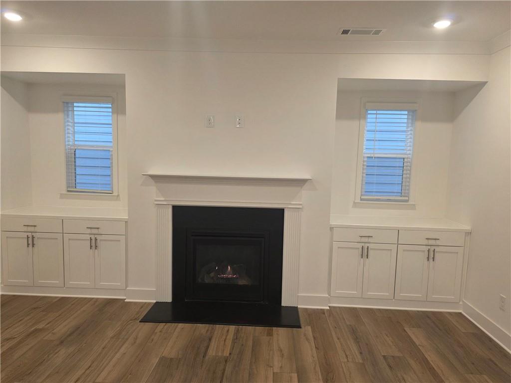 221 Brownlee Road Woodstock, GA 30188 - Photo 8 of 33 a view of a livingroom with a fireplace and wooden floor