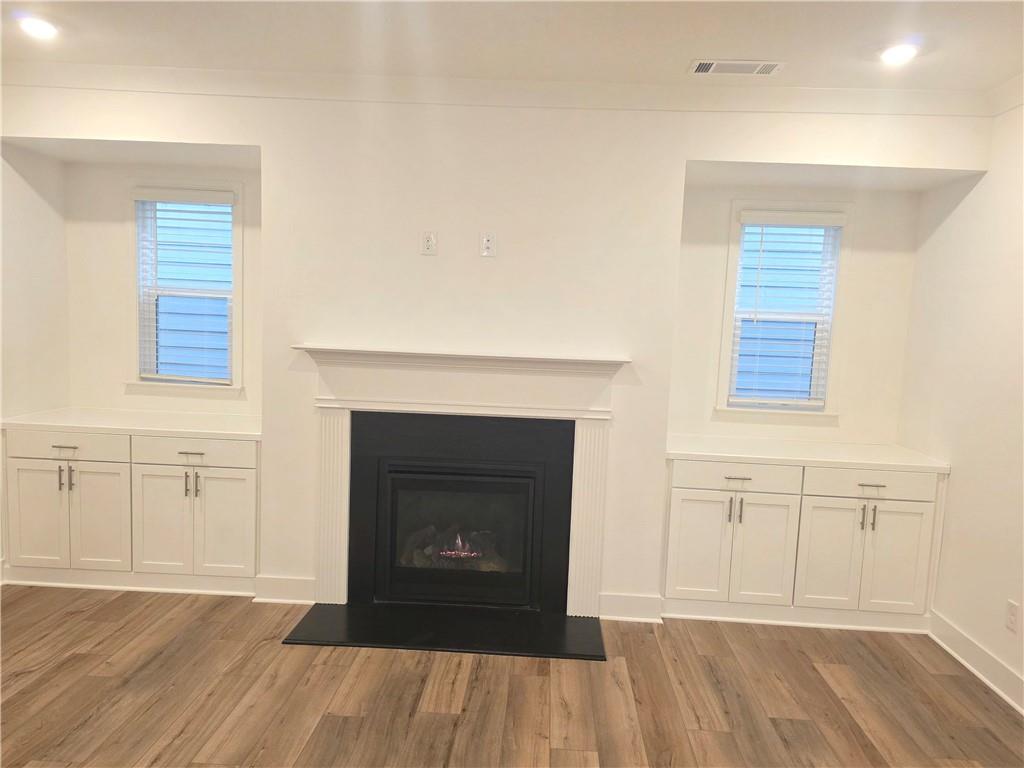 221 Brownlee Road Woodstock, GA 30188 - Photo 9 of 33 a view of a livingroom with a fireplace and wooden floor
