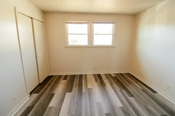 an empty room with wooden floor