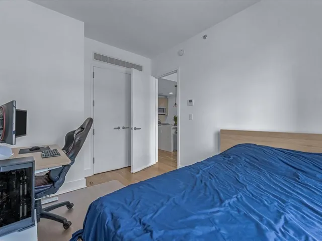 a bedroom with a bed and a chair