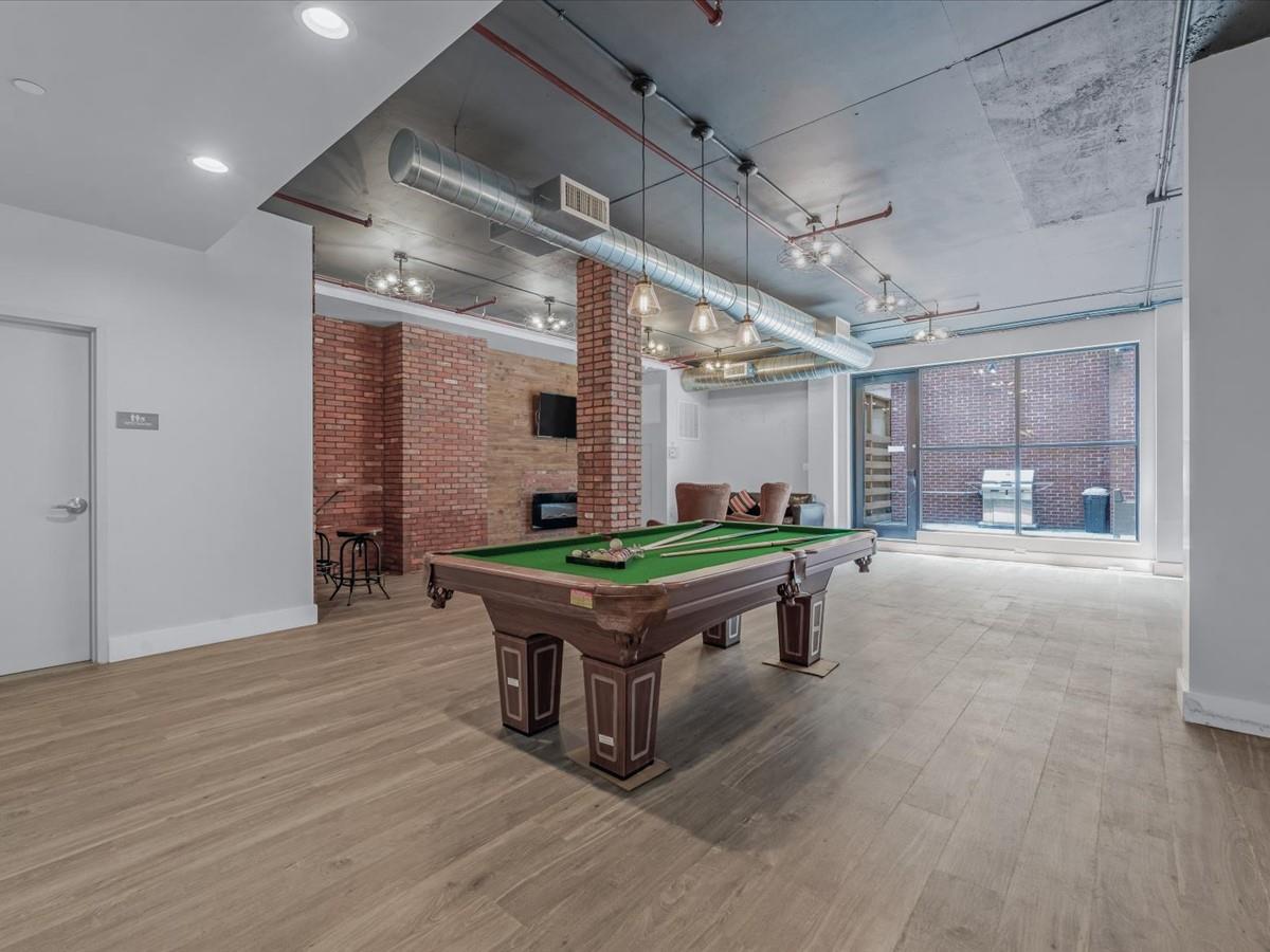 21-10 44th Drive, Unit 2B Queens, NY 11101 - Photo 13 of 19 a room with pool table wooden floor and windows