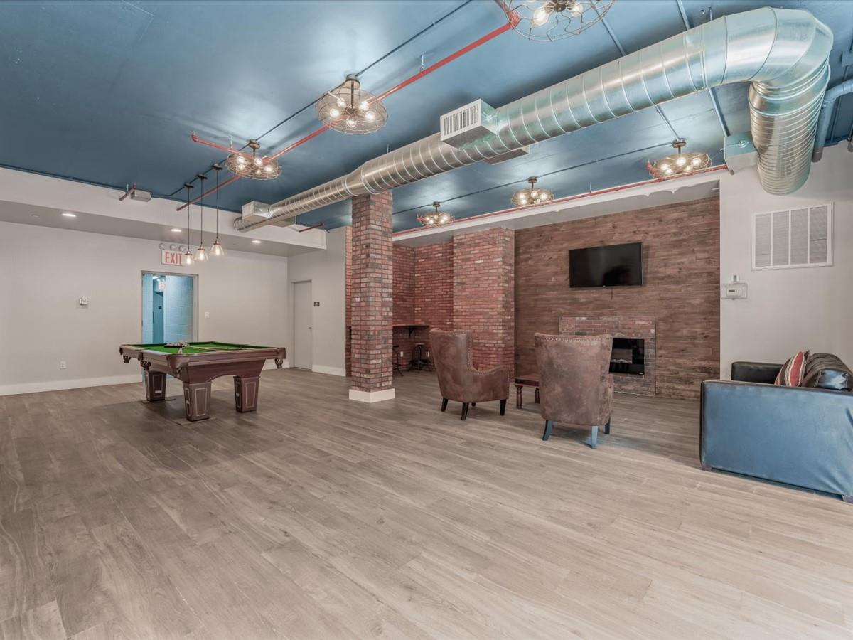 21-10 44th Drive, Unit 2B Queens, NY 11101 - Photo 14 of 19 a living room with furniture and a fireplace