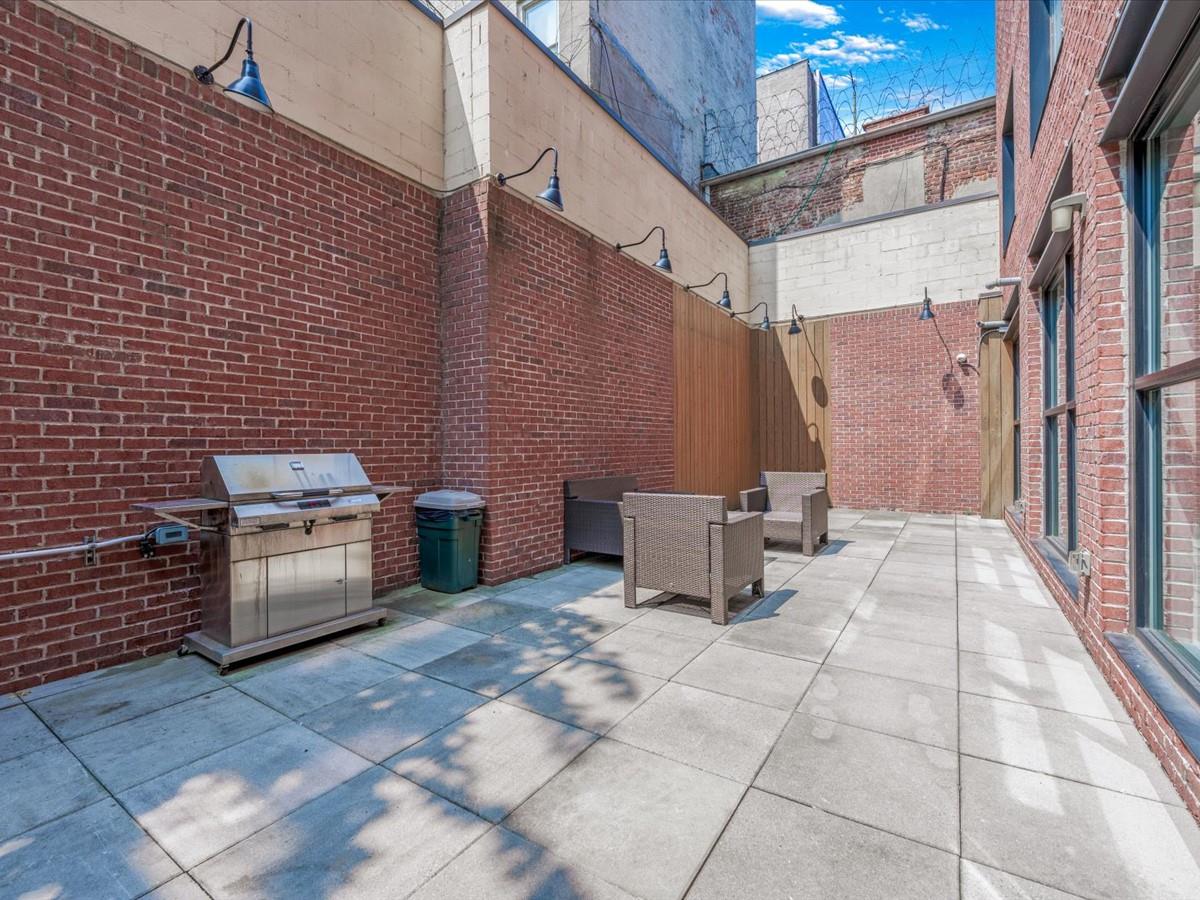 21-10 44th Drive, Unit 2B Queens, NY 11101 - Photo 17 of 19 a view of a patio with table and chairs