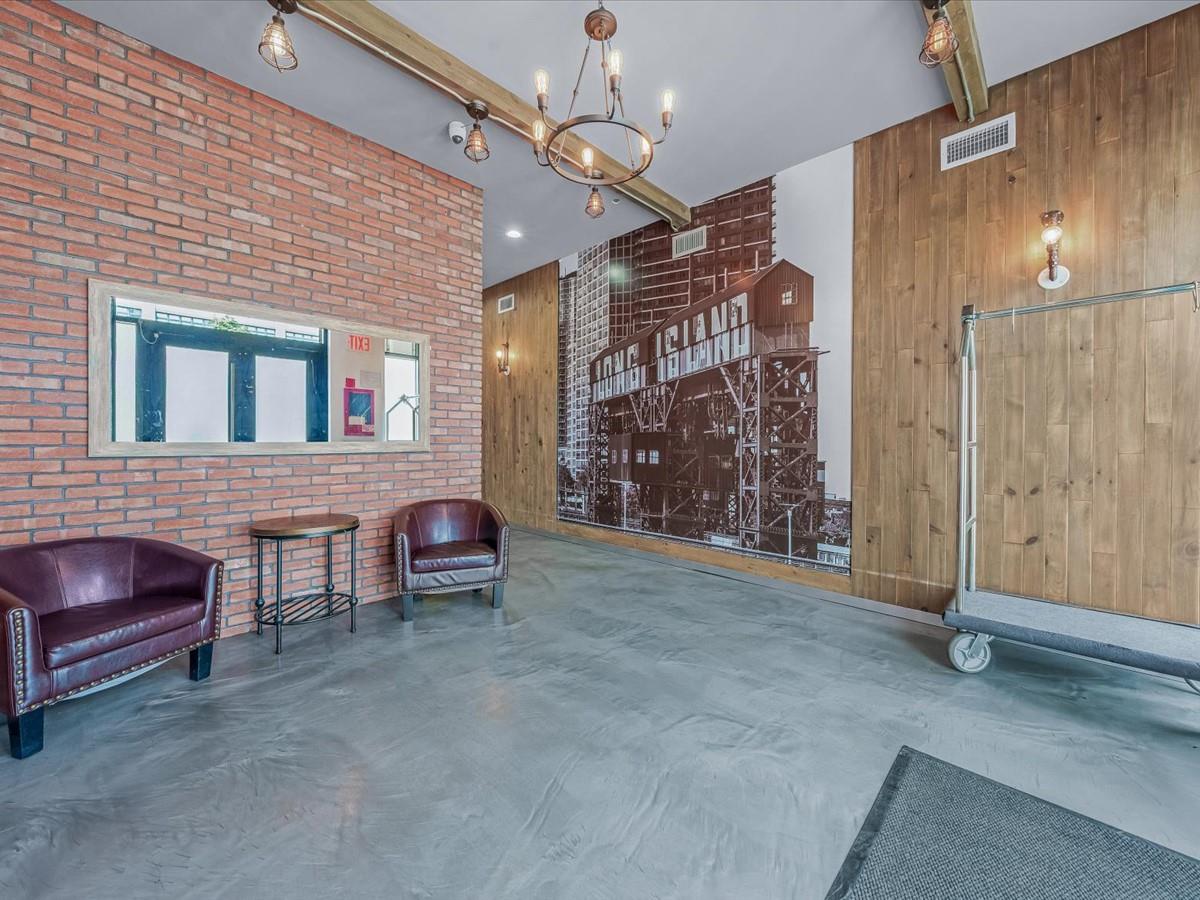 21-10 44th Drive, Unit 2B Queens, NY 11101 - Photo 2 of 19 a view of a livingroom with furniture and a ceiling fan