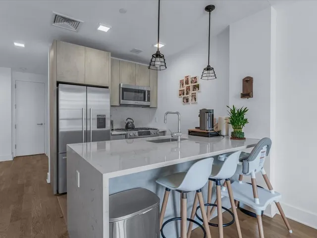 a view of kitchen with sink and wooden floor