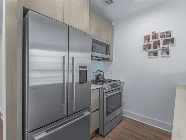 a kitchen with kitchen island a counter space a sink and appliances
