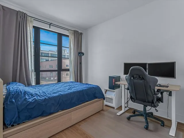 a living room with furniture and a dining table with kitchen view