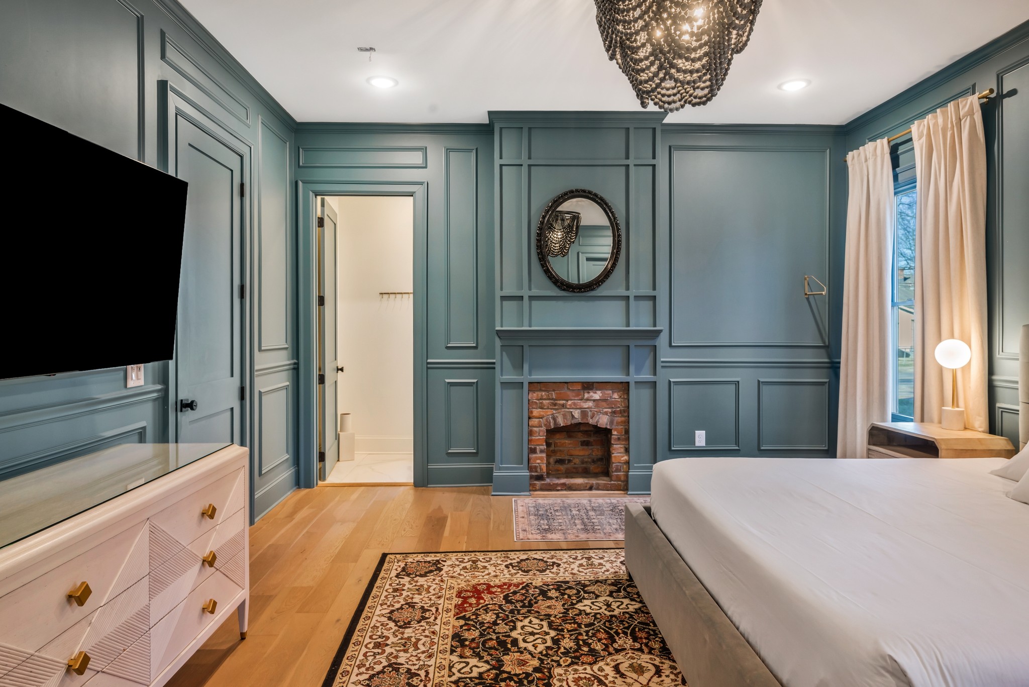 1007 Lischey Avenue Nashville, TN 37207 - Photo 21 of 52 a bedroom with a bed and a flat tv screen on dresser