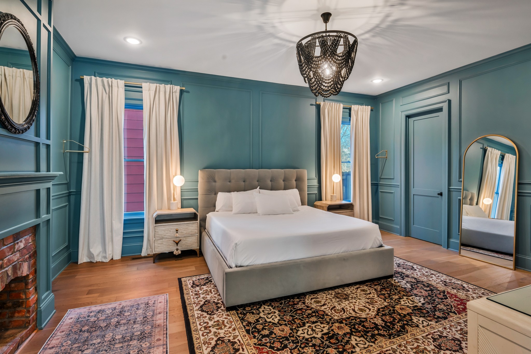 1007 Lischey Avenue Nashville, TN 37207 - Photo 22 of 52 a bedroom with a large bed and a chandelier
