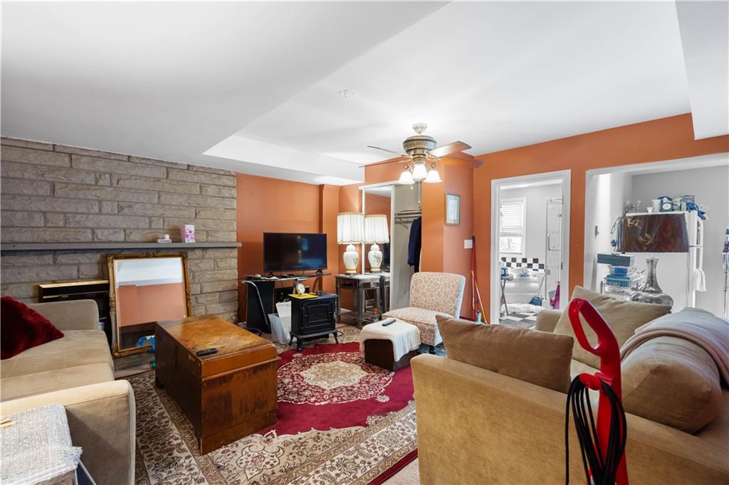 1580 Williamsburg Road Pittsburgh, PA 15243 - Photo 24 of 41 a living room with furniture a flat screen tv and a fireplace