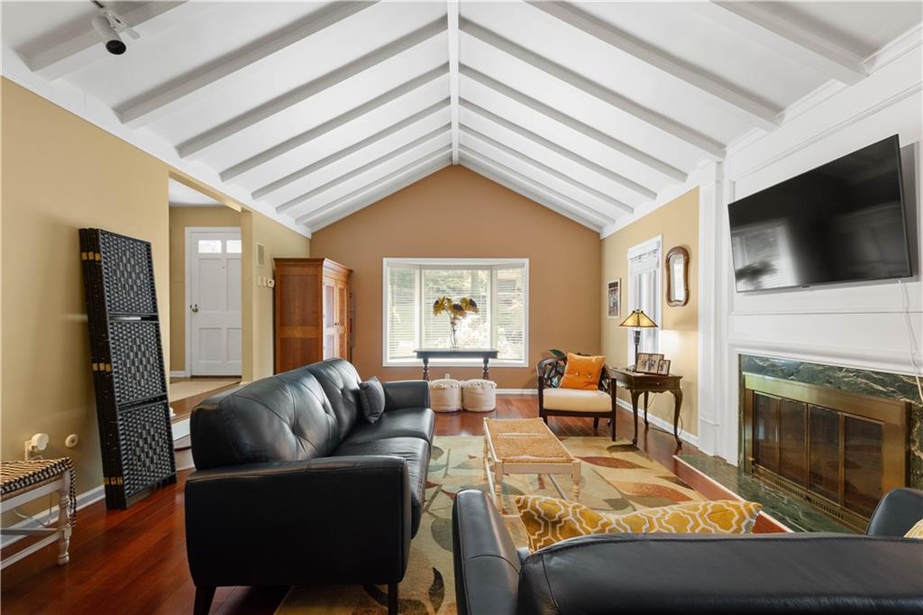 1580 Williamsburg Road Pittsburgh, PA 15243 - Photo 7 of 41 a living room with furniture a flat screen tv and a fireplace