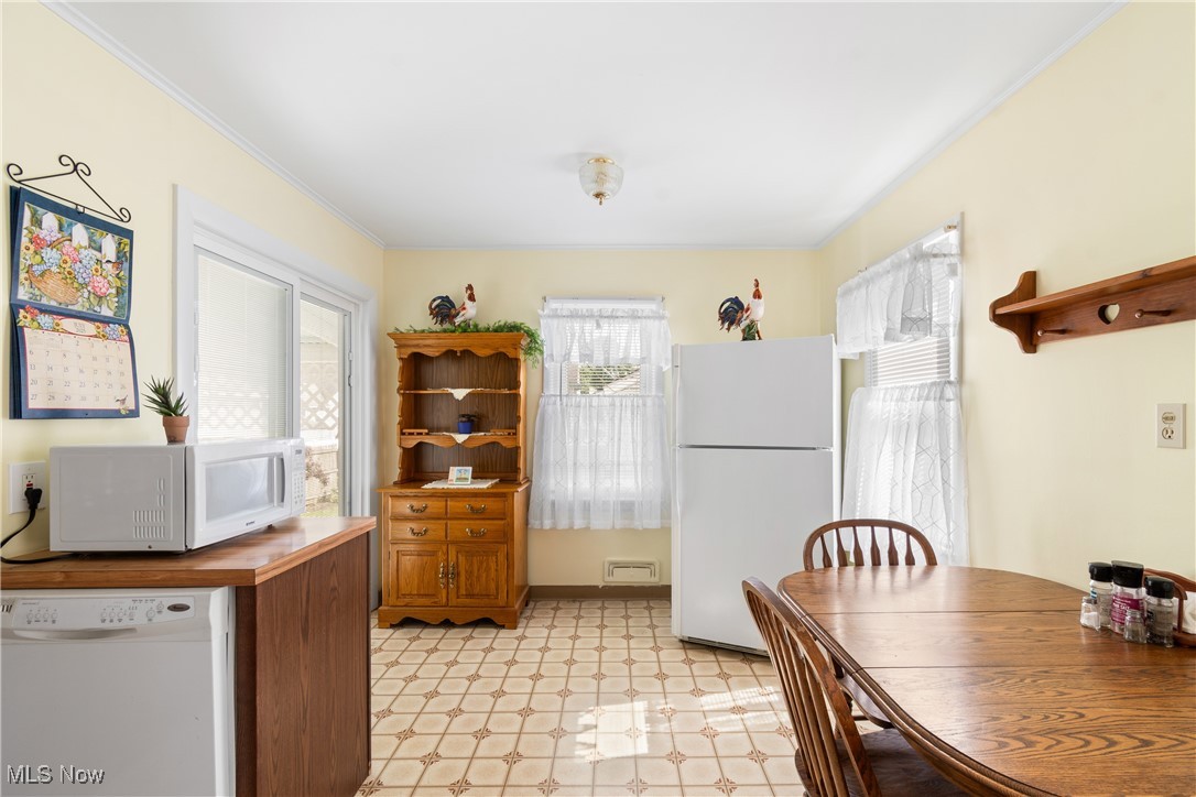 720 Ina Avenue Akron, OH 44306 - Photo 9 of 30 Kitchen featuring white appliances, light floors, wooden counters, and ornamental molding