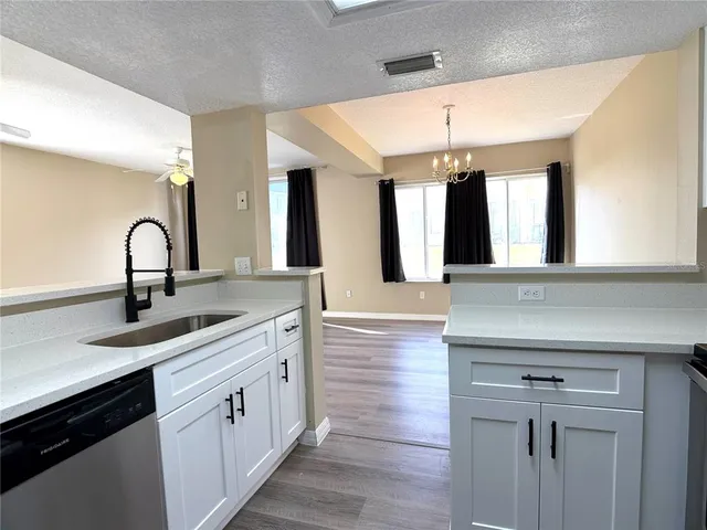 a kitchen with a sink cabinets and window