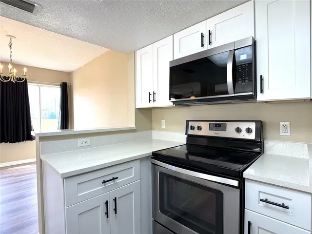 a kitchen with a stove and a microwave