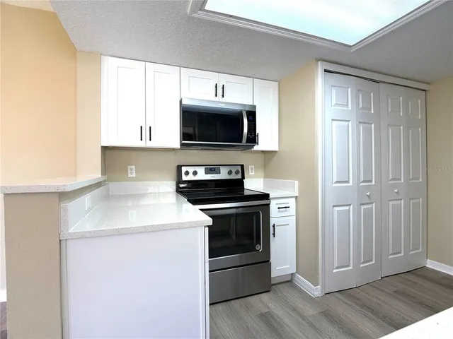 a kitchen with a stove and a microwave