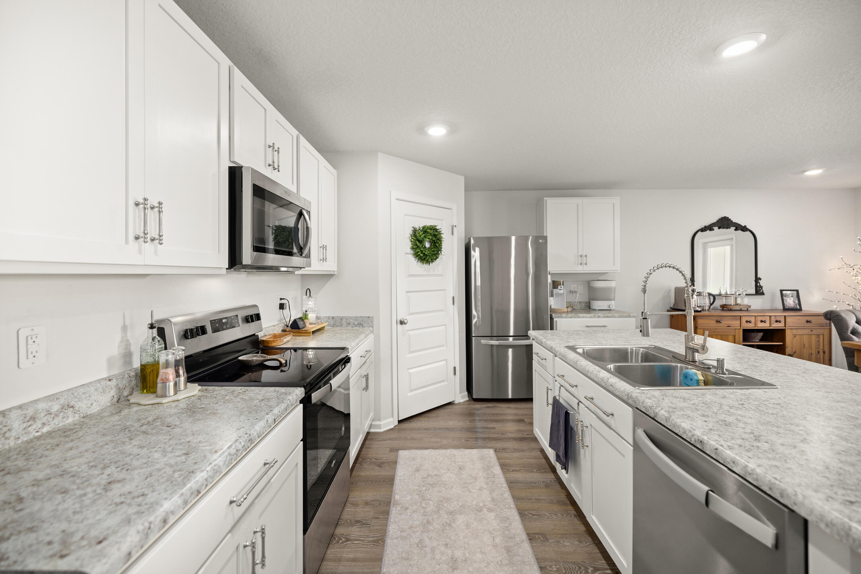 211 Laurel Hill Street Crestview, FL 32539 - Photo 12 of 60 a kitchen with a sink stove and refrigerator
