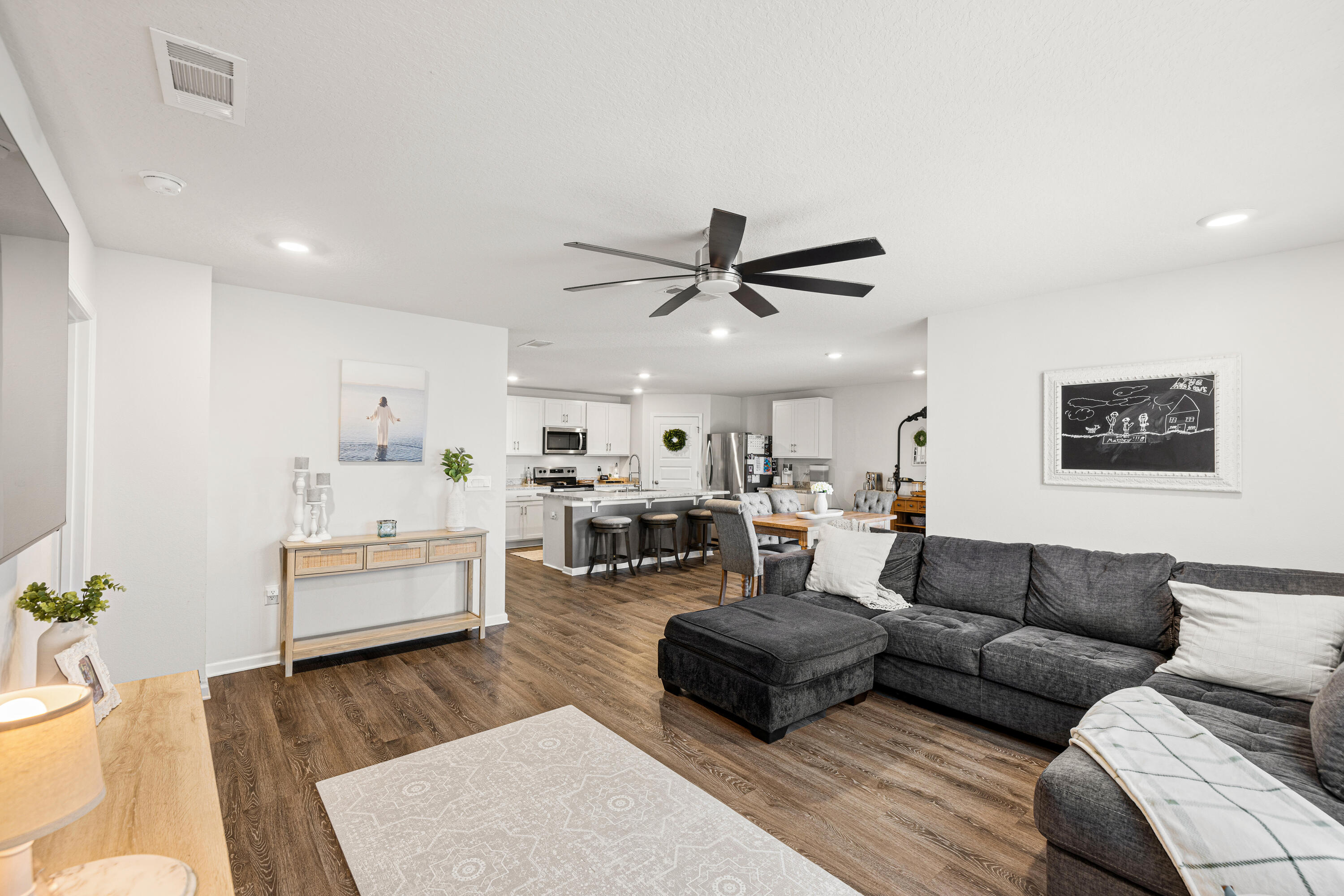 211 Laurel Hill Street Crestview, FL 32539 - Photo 19 of 60 a living room with furniture and a wooden floor