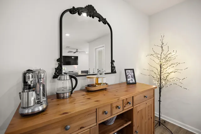 a en suite bathroom with a granite countertop sink and a mirror