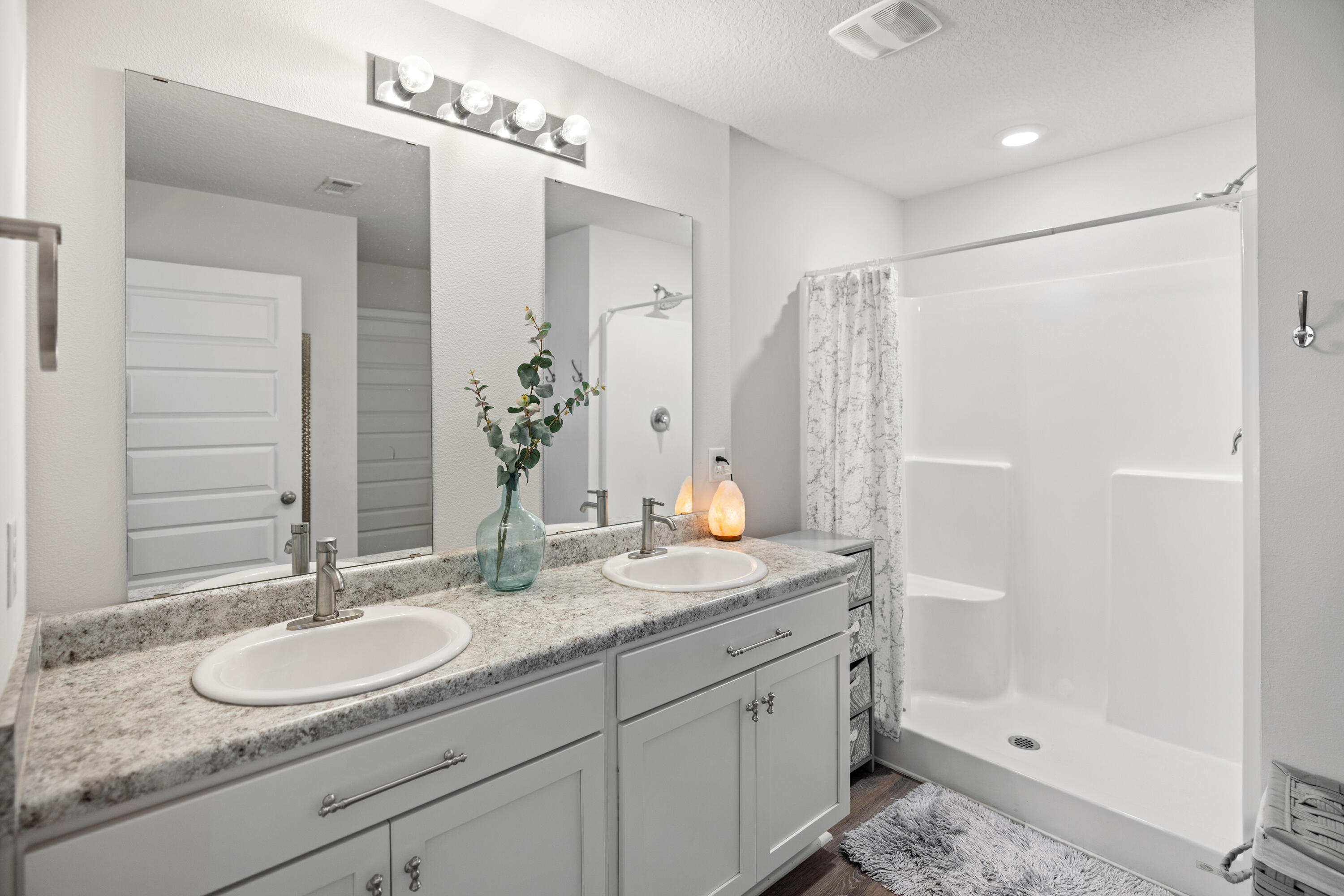 211 Laurel Hill Street Crestview, FL 32539 - Photo 28 of 60 a bathroom with a granite countertop double vanity sink and shower