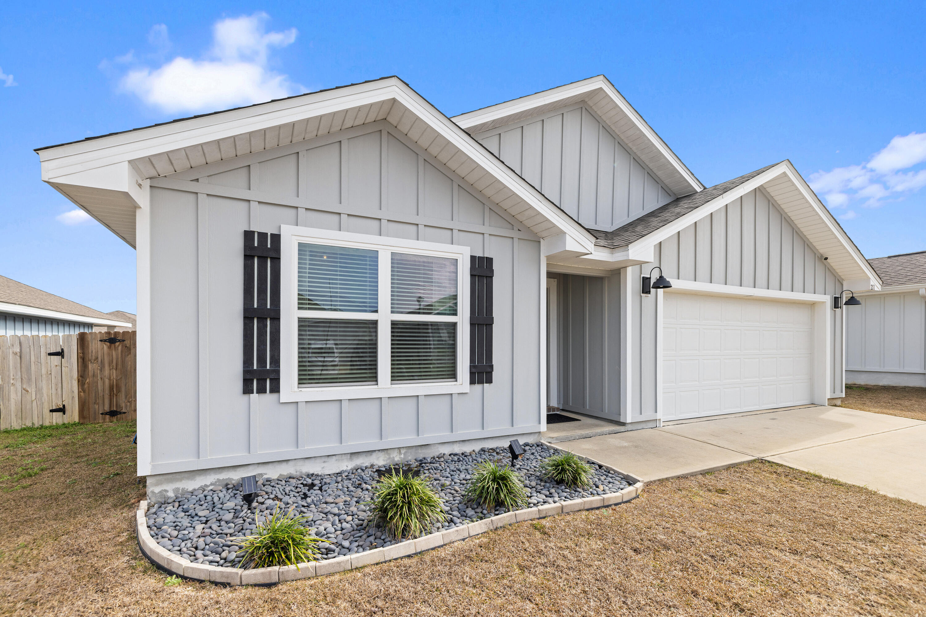 211 Laurel Hill Street Crestview, FL 32539 - Photo 3 of 60 a front view of a house with a yard