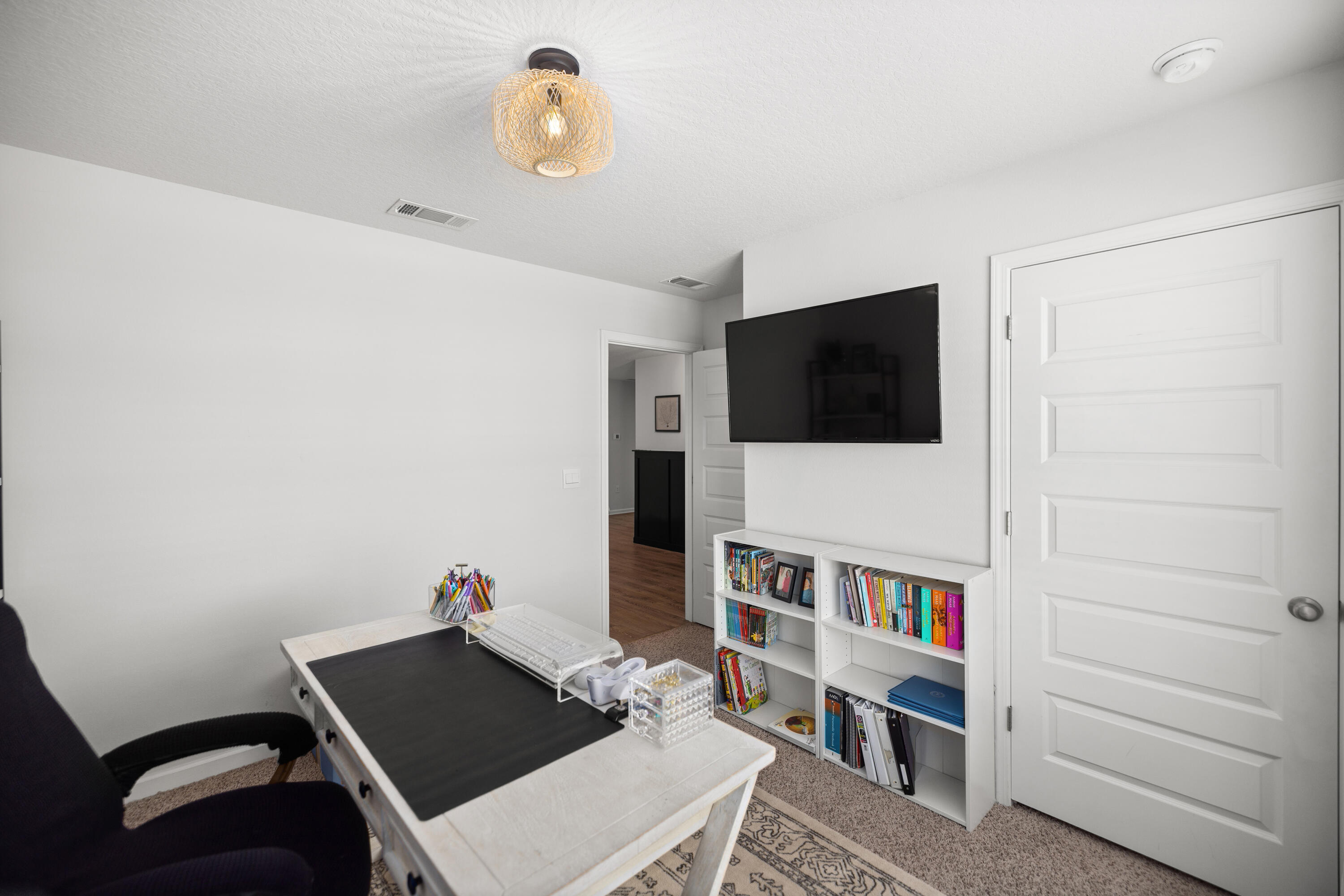 211 Laurel Hill Street Crestview, FL 32539 - Photo 41 of 60 a living room with a flat screen tv and a book shelf