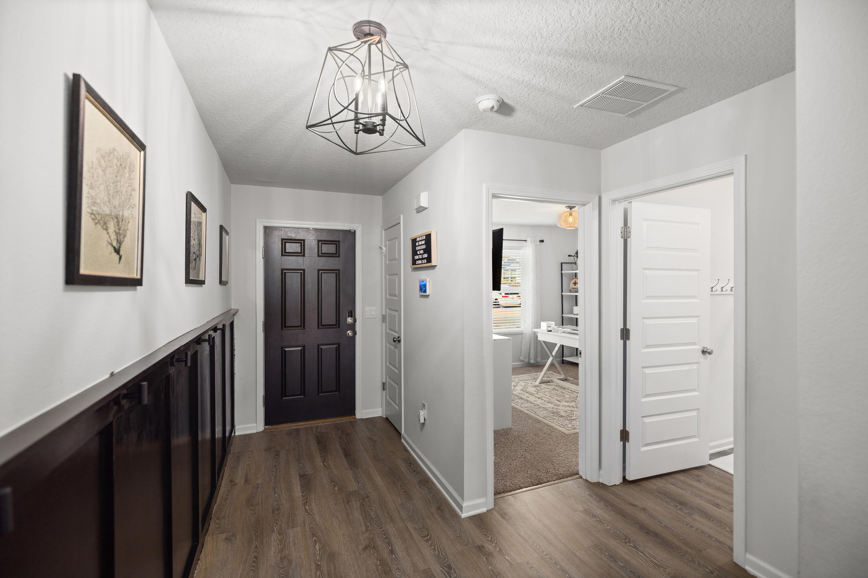 211 Laurel Hill Street Crestview, FL 32539 - Photo 7 of 60 a view of a hallway with wooden floor and closet