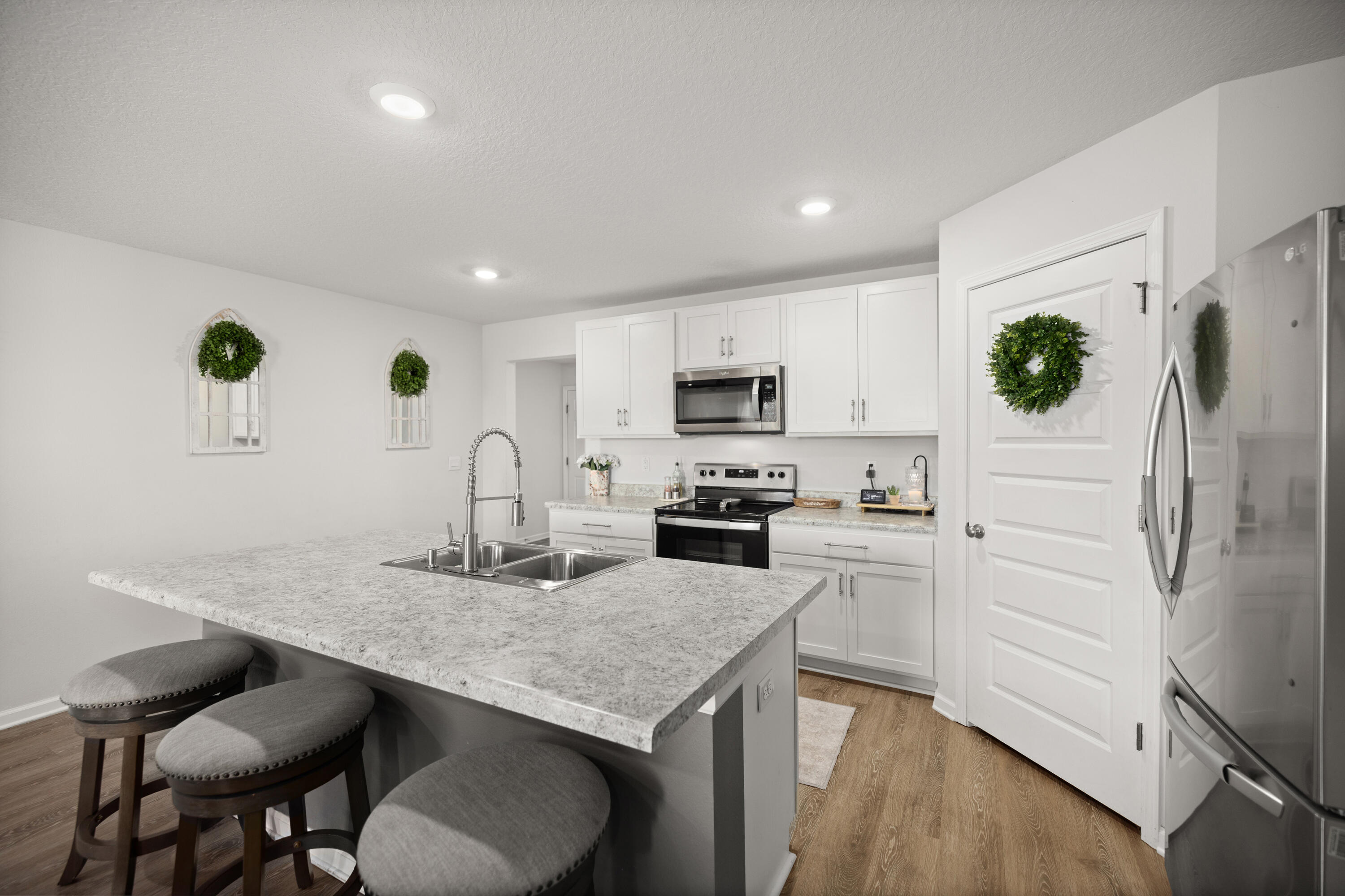 211 Laurel Hill Street Crestview, FL 32539 - Photo 9 of 60 a kitchen with granite countertop white cabinets and stainless steel appliances
