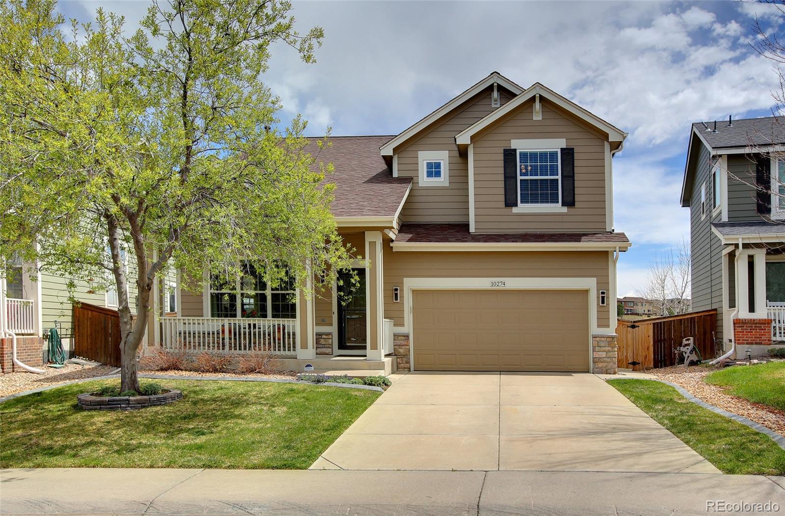 10274 Willowbridge Court Highlands Ranch, CO 80126 - Photo 1 of 35 a front view of a house with a yard and garage