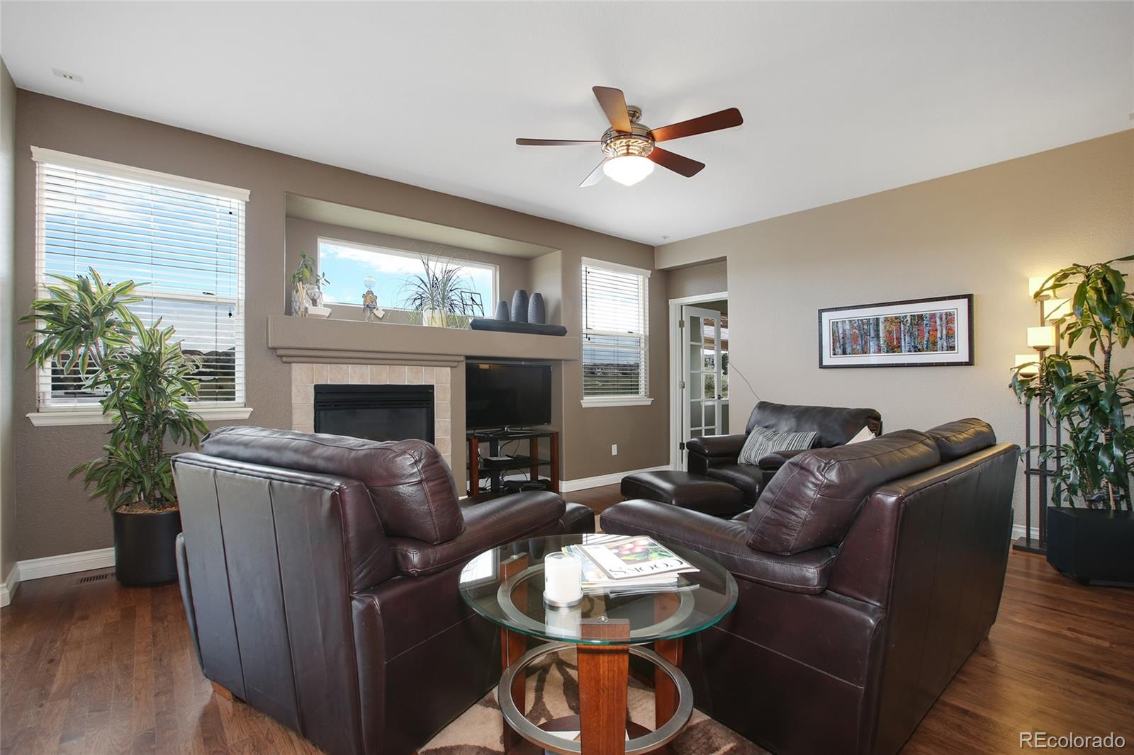 10274 Willowbridge Court Highlands Ranch, CO 80126 - Photo 13 of 35 a living room with furniture a fireplace and a large window