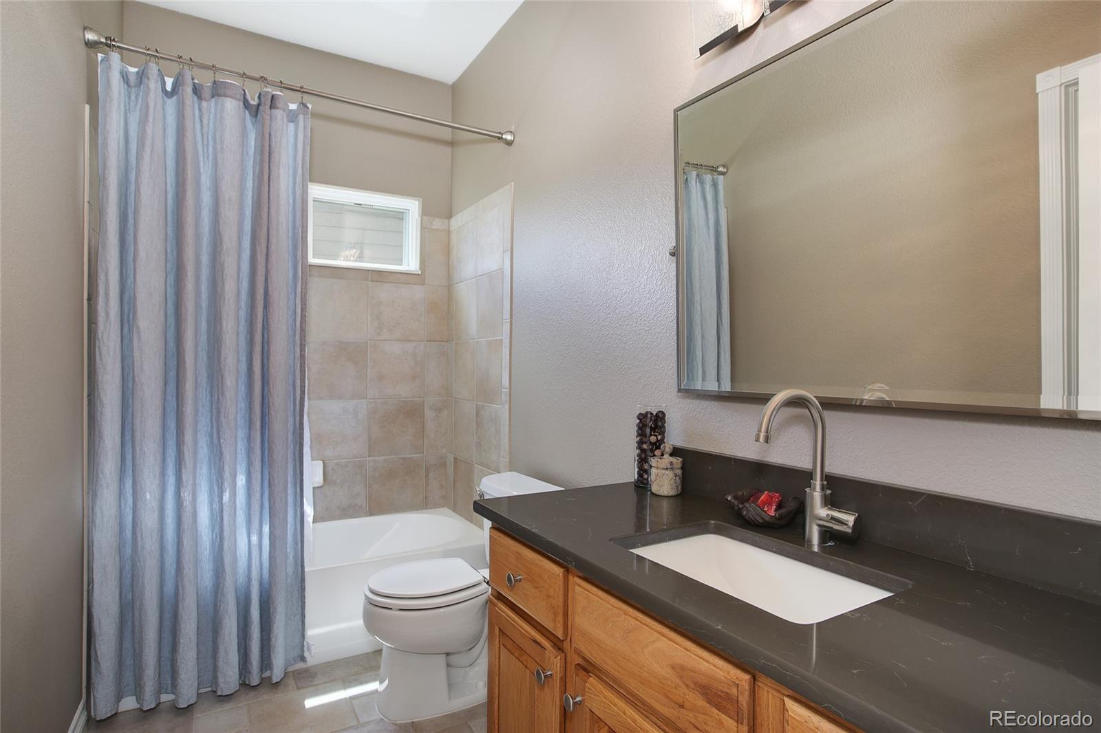 10274 Willowbridge Court Highlands Ranch, CO 80126 - Photo 16 of 35 a bathroom with a sink a toilet and shower