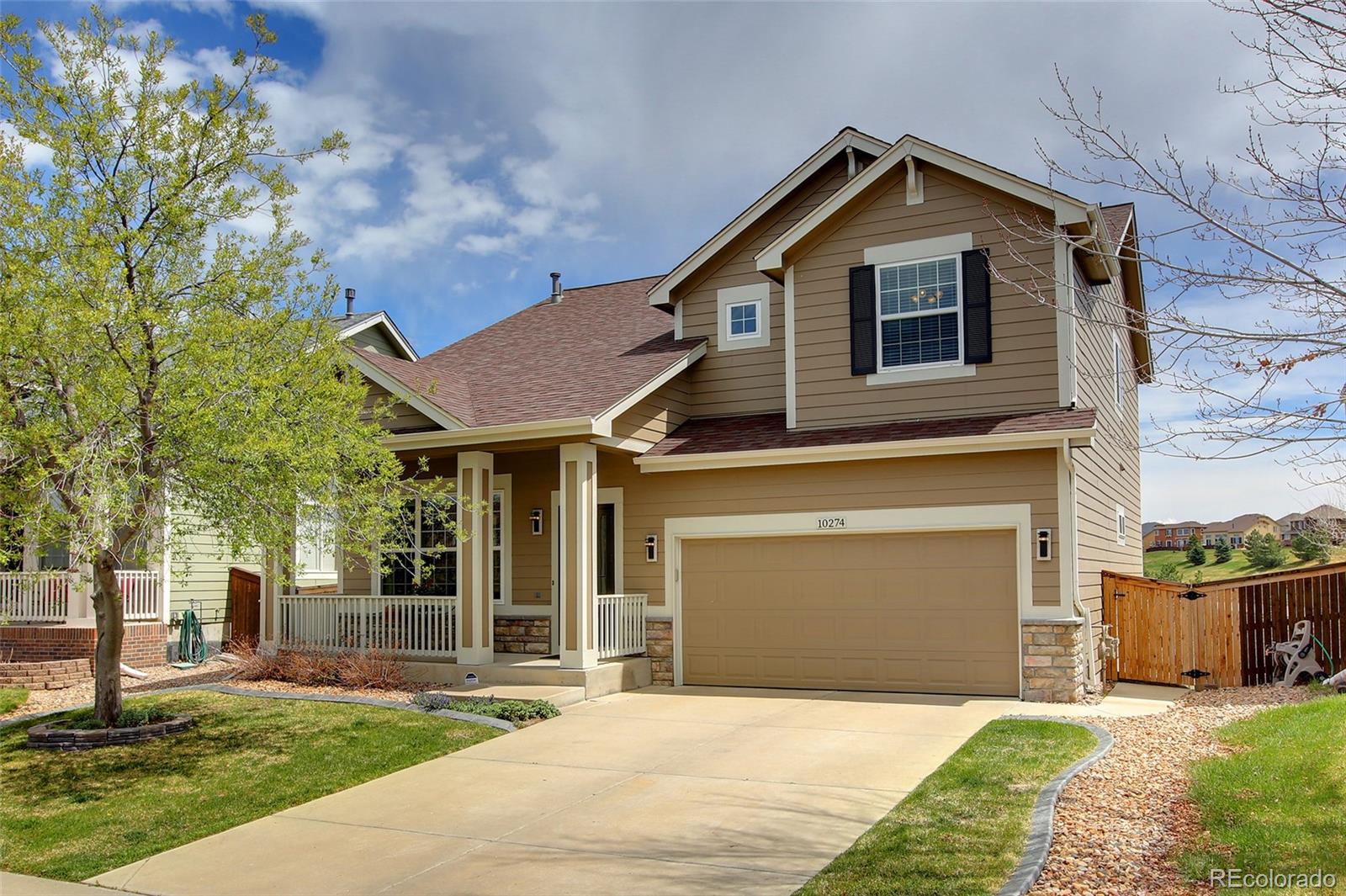 10274 Willowbridge Court Highlands Ranch, CO 80126 - Photo 2 of 35 a front view of a house with a yard and garage