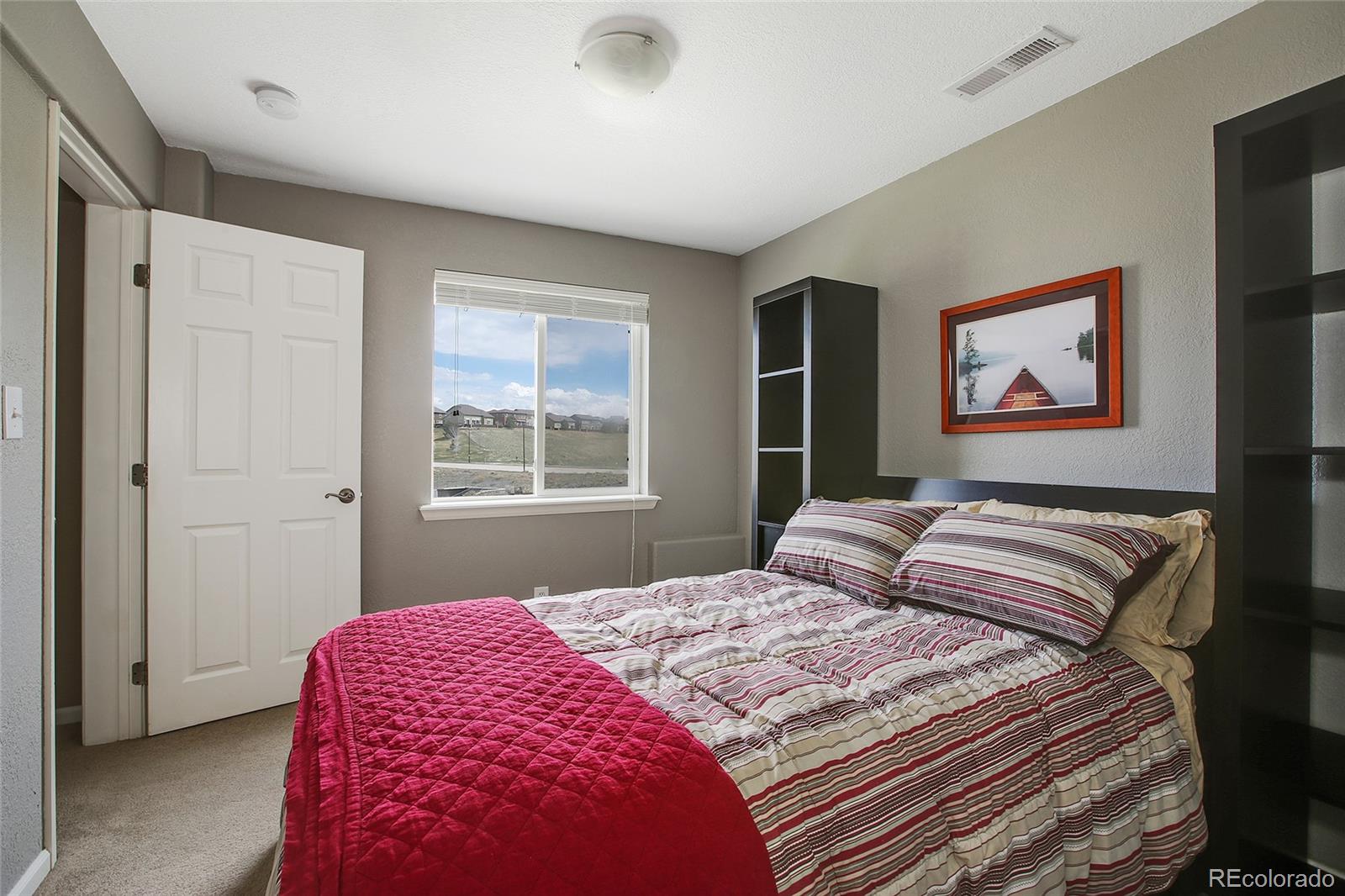 10274 Willowbridge Court Highlands Ranch, CO 80126 - Photo 27 of 35 a bedroom with a bed and a window