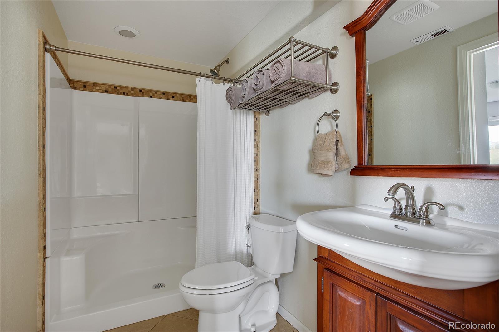 10274 Willowbridge Court Highlands Ranch, CO 80126 - Photo 28 of 35 a bathroom with a sink toilet and shower