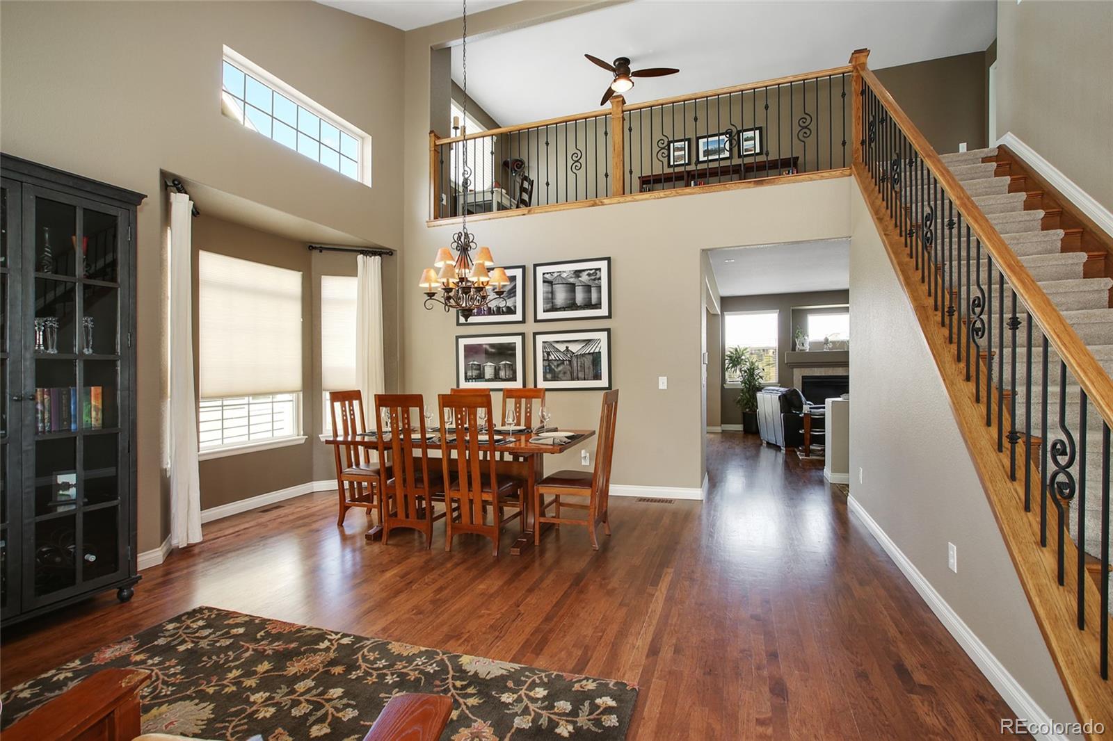 10274 Willowbridge Court Highlands Ranch, CO 80126 - Photo 5 of 35 a view of a livingroom with furniture window and wooden floor