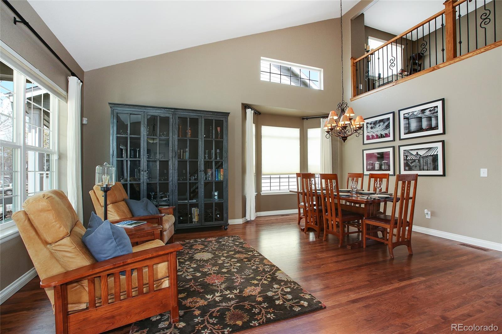 10274 Willowbridge Court Highlands Ranch, CO 80126 - Photo 6 of 35 a dining room with furniture a rug and wooden floor