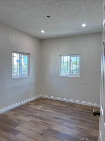 a view of a room with wooden floor and window