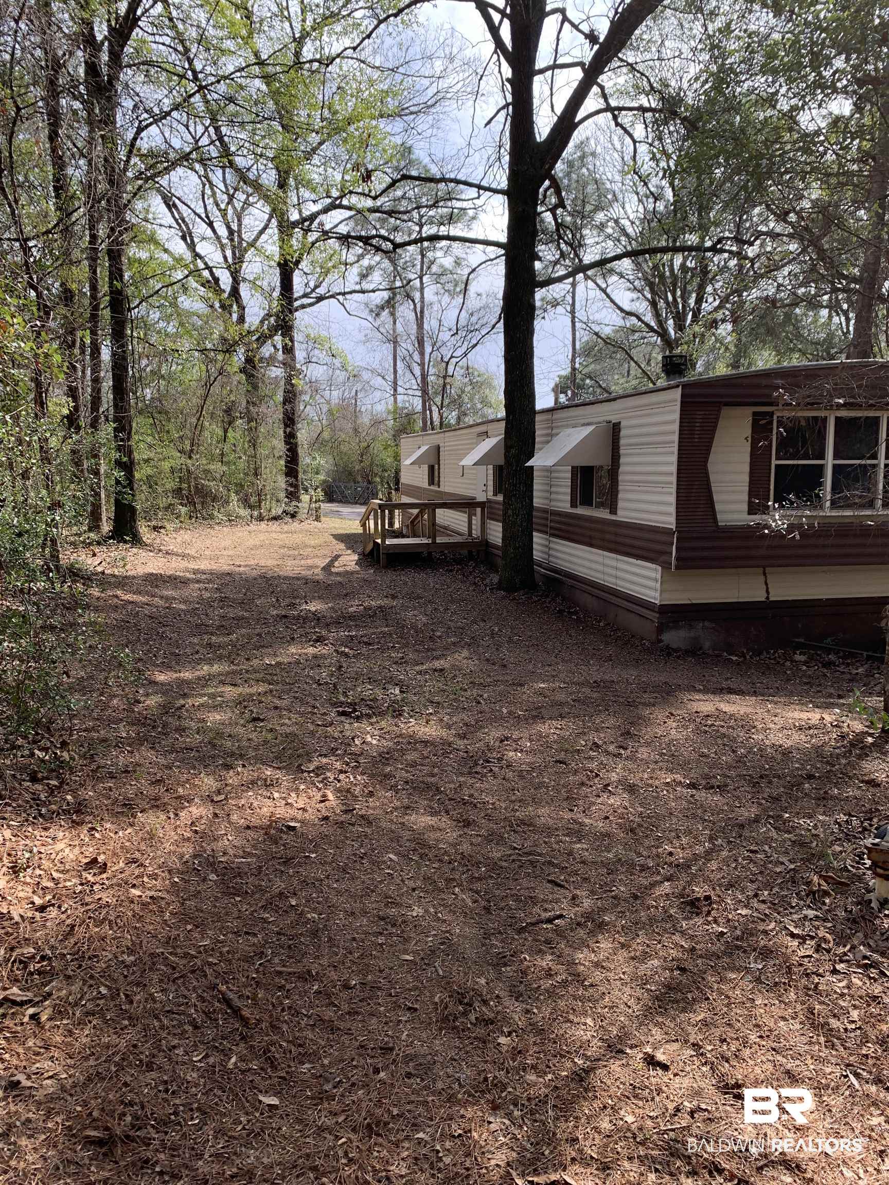 15575 Rogers Drive Chunchula, AL 36521 - Photo 2 of 42 View of yard with a wooden deck