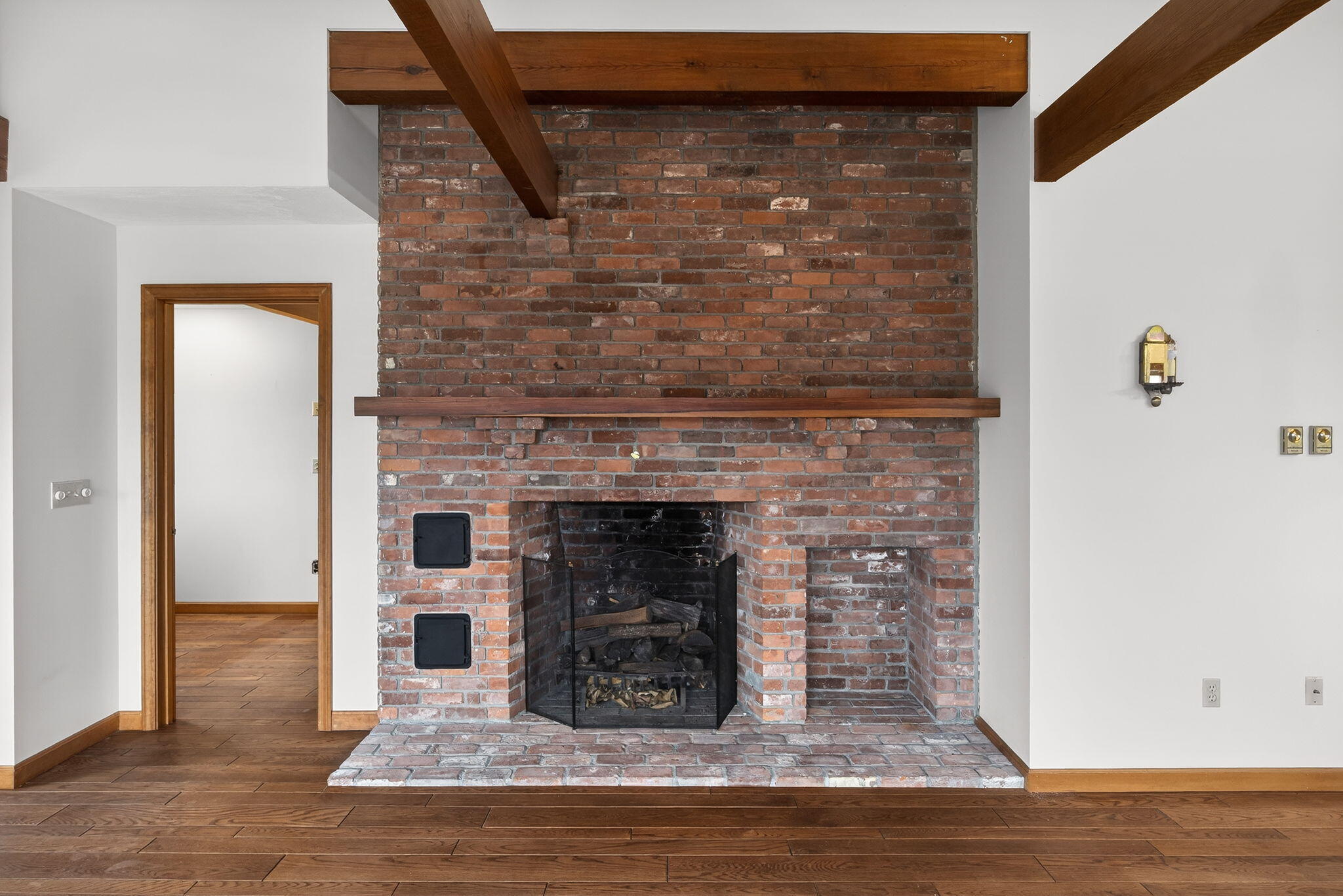 4 Earl Road East Sandwich, MA 02537 - Photo 18 of 63 a view of an empty room with wooden floor and a fireplace